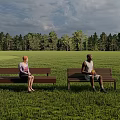 Comfortable Landscape Seats In Lush Green Field With Forest And Cloudy Sky