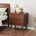 Wooden Nightstand With Two Drawers Brass Lamp Orange Flowers And Book In Bedroom