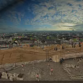 Ancient Architecture Construction Site With Workers And Materials Amid Cityscape And Cloudy Sky