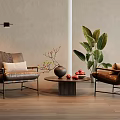 Modern Living Room Featuring Leather Armchairs Coffee Table Floor Lamp And Green Plants