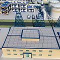 Modern Industrial Factory Building With Flat Roof Storage Tanks And Steel Towers