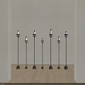 Multiple Black Candle Lamps With White Candles In Indoor Scene Wooden Floor Beige Walls