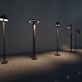 Modern Floor Lamps With Various Designs Metal Stands And Illuminated Shades Against Minimalist Wall