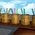 Brown Decorative Pen Holders With Gold Patterns Holding Colorful Pens On Wooden Shelf