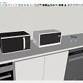 Modern Two Black And White Microwave Ovens On White Countertop With Light Gray Wall