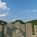 Scenic Mountain Highway Bridge With Tunnel And Forested Surroundings Under Blue Sky