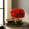 Red Roses in Gold Vase on Black Marble Table with Gold Bowl and Gray Wall