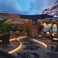 Outdoor Restaurant Terrace with Umbrellas Tables Chairs Green Plants Stone Path Lighting and Sunset Sky