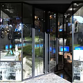 Modern Internet Cafe Interior With Bar Counter Screens And Beverage Shelves