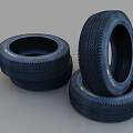 High Quality Car Tires Stacked on Gray Background for Vehicle Maintenance