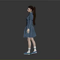 Woman Wearing Blue Dress with Braid and Blue Shoes Standing Against Gray Background