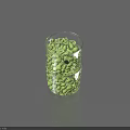 Green Fruits in Transparent Glass Cup Wrapped with Metal Mesh on Gray Surface