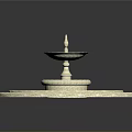 Multi Tiered Circular Fountain Design With Blue Water And Light Colored Edges