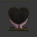 Black Heart Shaped Decorative Ornament Held By White Hands On Black Base