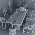 Wooden Chinese Style Tea Table And Chairs With Tea Set Green Plants And Water Feature
