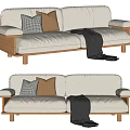 Modern White Fabric Two Seater Sofa With Gray Checkered Brown Pillows And Black Throw Blanket