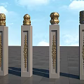 Gray Stone Pillars With Golden Ornate Tops And Intricate Carvings In Open Area