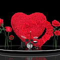 Heart Shaped Rose Art Installation With Red Roses Around Black Platform And Drums