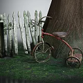 Old Red Tricycle Parked Beside White Wooden Fence And Large Tree On Grassy Ground