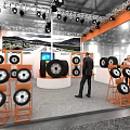 Modern Exhibition Booth With Displayed Tires Orange Gray Design Lighting And Screen