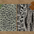Two Square Rugs With Black And White Fan And Leaf Patterns On Wooden Floor