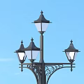 Outdoor Decorative Lamp Post with Multiple Pointed Top Lights and Blue Sky Background