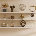 Elegant Metallic Decorative Ornaments Set With Geometric Shapes On White Shelves