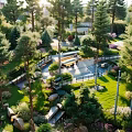 Park Landscape With Lush Pines Green Lawns Winding Pathways Colorful Flower Beds And Serene Seating