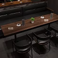 Modern Dining Area With Long Wooden Table Black Chairs Booth Seating And Potted Plant