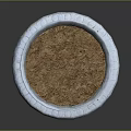 Decorative Round Stone Planter With Carved Details And Soil Filled Interior