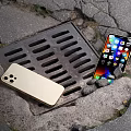 Gold iPhone And Modern Smartphone With Bright Screen Displaying Apps On Outdoor Surface