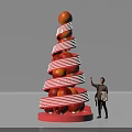 Person Standing Next To Decorative Peach Tower With Red And White Stripes Holding Shopping Bag