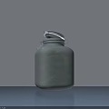 Ceramic Jar With Silver Metal Lid On Gray Countertop Against White Background