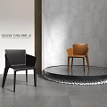 Modern Black And Brown Accent Chairs In Contemporary Interior With Round Pebble Trim Platform