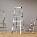 Metal Ladders of Various Heights in Indoor Setting With Wooden Floor