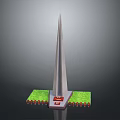 Tall Pointed Top Monument Structure With Green Lawn And Red Plaque Base