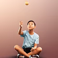 Man Sitting On Floor In Light Blue T-Shirt Raising Right Hand Against Brown Background