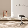 Wooden and Black Stools in Indoor Space with Natural Light and Shadow Patterns
