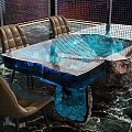 Unique Table and Chairs Set with Blue Ice-like Transparent Tabletop Lighting and Brown Leather Chairs