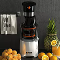 Modern Electric Juicer With Fresh Pineapple Oranges And Towel On Gray Background