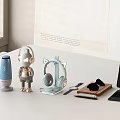 Modern Over Ear Headphones And Blue Bluetooth Speaker With Cat Ear Stand On Desktop Table