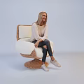Smiling Woman Sitting On Wicker Chair With Light Top Dark Jeans Light Shoes