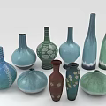Assorted Colored Ceramic Vases In Different Shapes Holding Fresh Green Plants