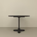 Minimalist Black Round Dining Table With Unique Base In Light Colored Room 3d model