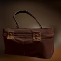 Brown Leather Bag With Top Handle And Front Metal Buckle Design
