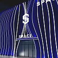 Blue Wavy Storefront Design With White Lighting Lines And SPACE Sign Entrance