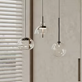 Modern Transparent Glass Pendant Lights With Spherical And Bell Shapes Hanging In Interior Space