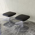 Modern Black Stools With Silver Metal Legs Against Light Wall On Marble Floor
