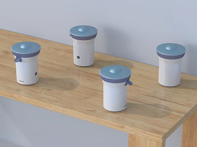 Four Compact White Household Appliances With Blue Lids On Wooden Table 3d model