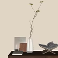 Fresh Aquatic Plant Sprig in Transparent Vase with Books and Blinds Shadow on Light Wall